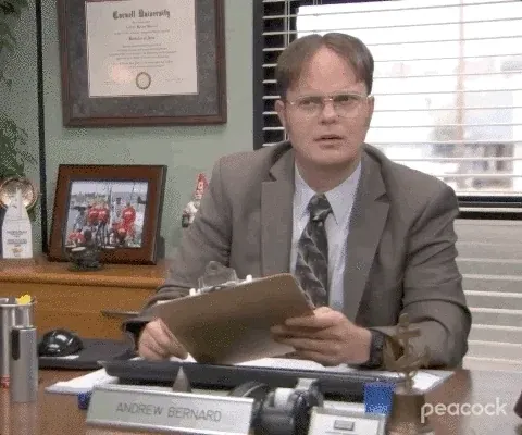 A short clip of Dwight Schurte, from the show The Office, appearing awkward and uncomfortable while holding a clipboard.